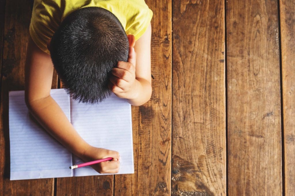 vecteezy boy laying on wood floor writing in notebook 2087775