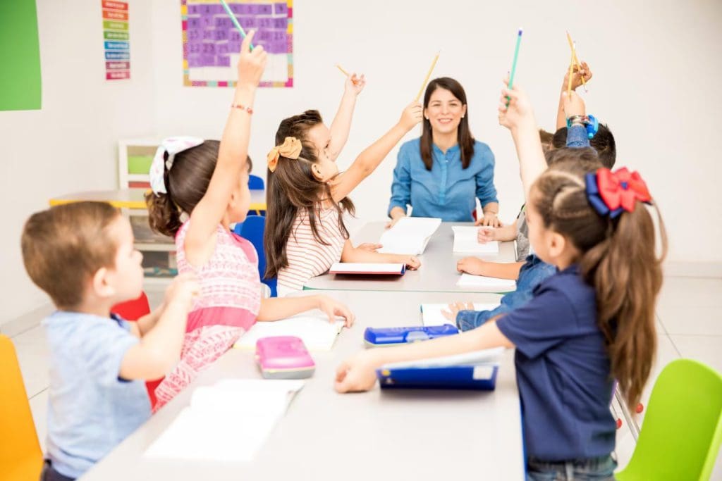 group preschool students raising their hands during class trying participate 662251 1622 conv